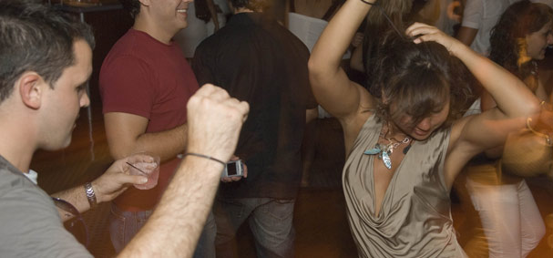 A girl shows her rhythm to the music played by the dj on the dance cruise in Miami.