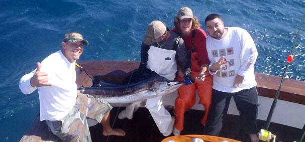 A few guys take a photo after catching a sailfish while fishing off the Miami coastline. 