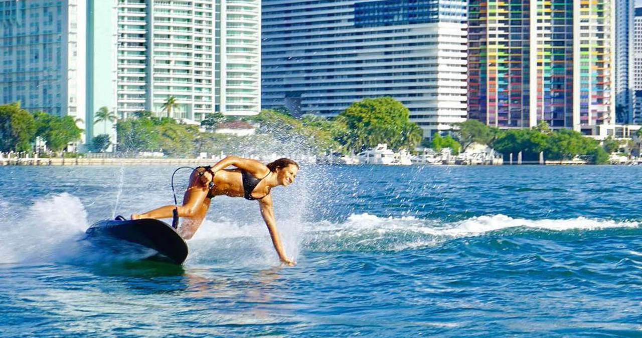 A professional women pilot rips on the water in Miami