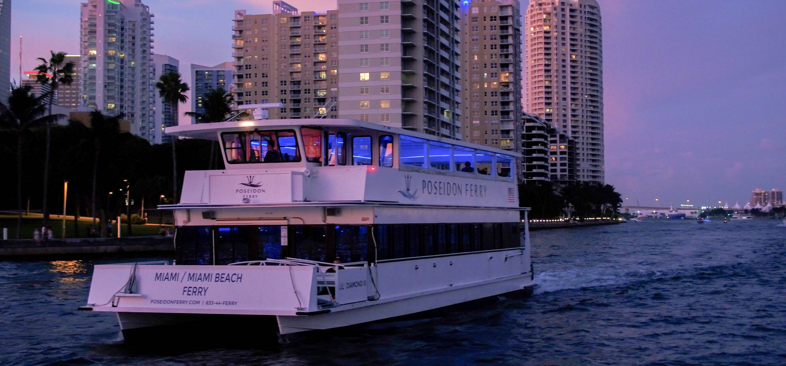 The Poseidon Ferry cruises during the dusk to reveal the city skyline lights. 