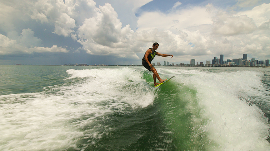 Garrison enjoy a wake surf with Downtown Miami visible in the background. 