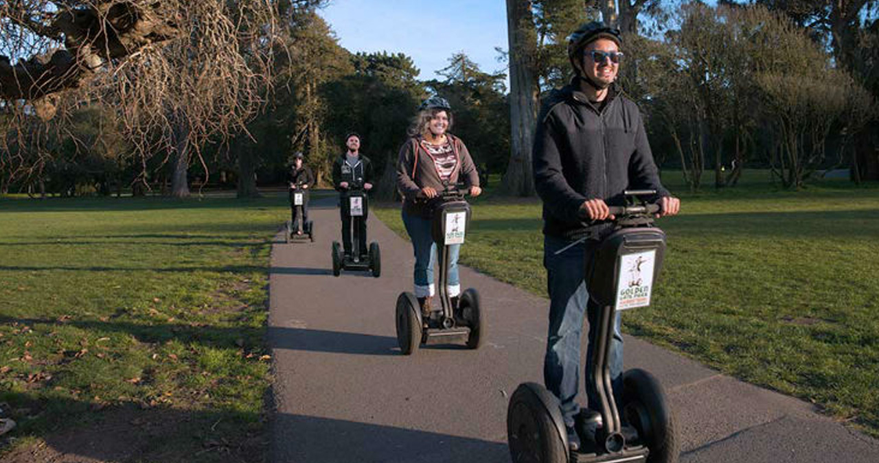 A group cruises through San Francisco on Segways. 