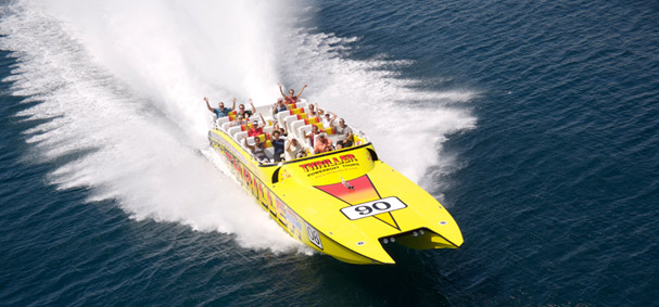 Passengers wave to the camera as the Thriller Speedboat races around Miami.